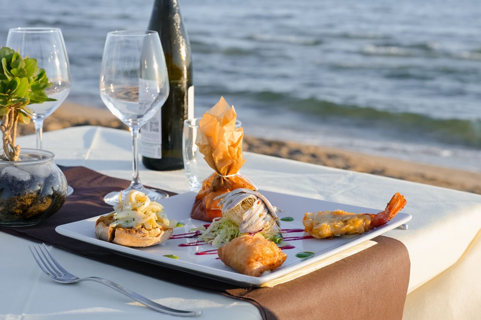 Seafood antipasto plate on a table at the water's edge