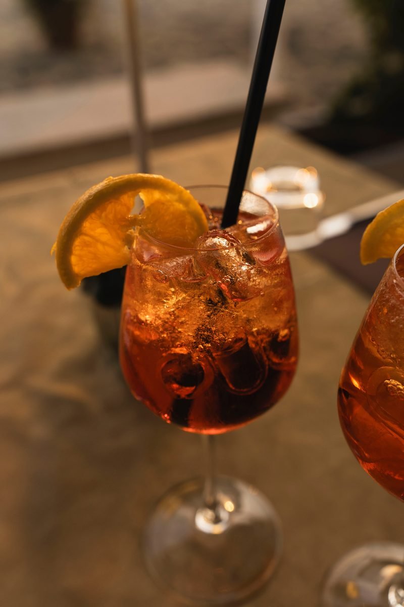 Spritz with orange slice and straw, close-up